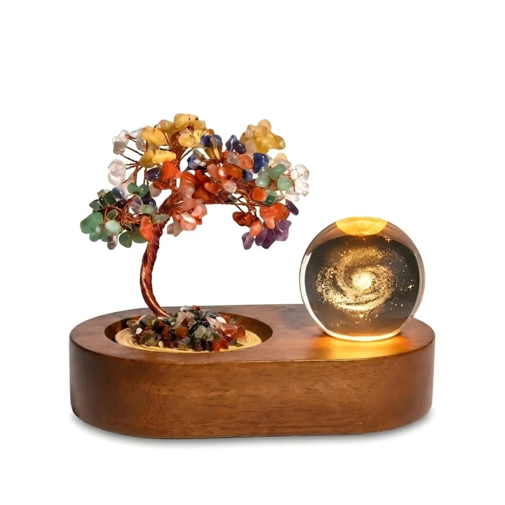 Chakra gemstone tree and a clear 3D Milky Way crystal ball on a solid wood base