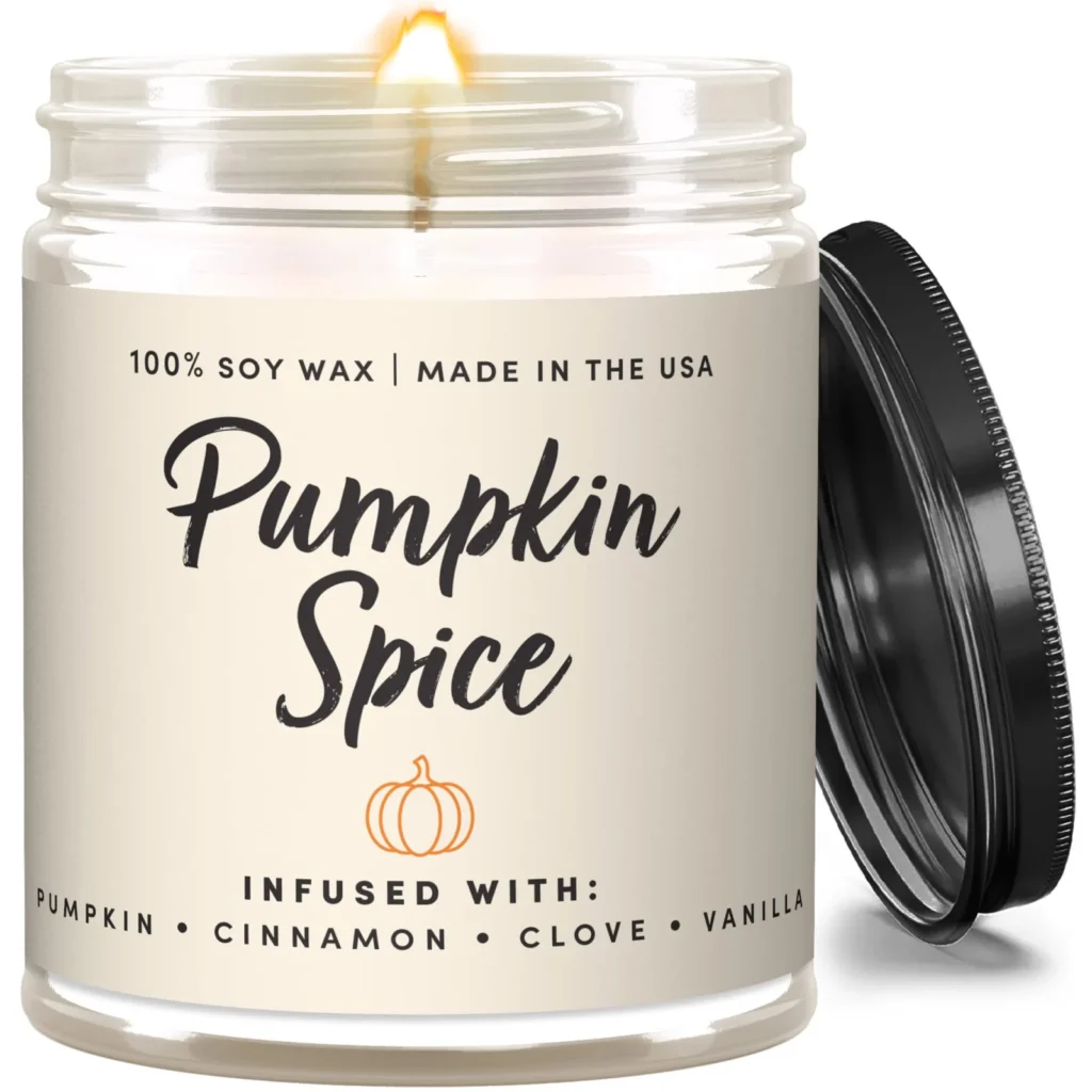 Wax & Wit pumpkin spice soy candle in a clear glass jar with a matte black lid